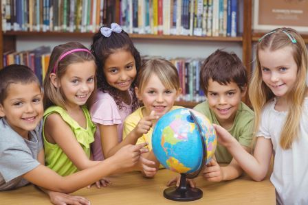 Children at Spanish Class Pointing at a Globe